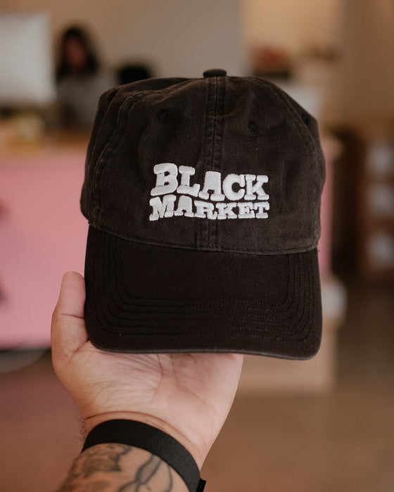 Hand holding a custom embroidered black item