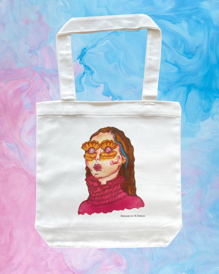White tote bag printed with a portrait on a tie-dye background