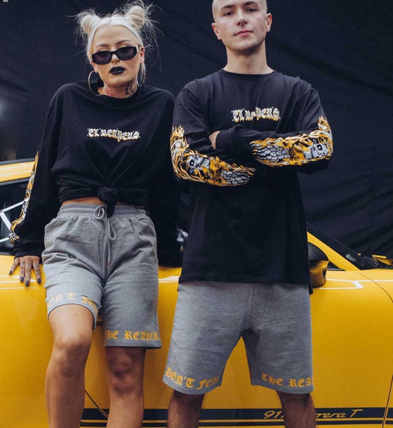 Two people wearing custom printed t-shirts outdoors